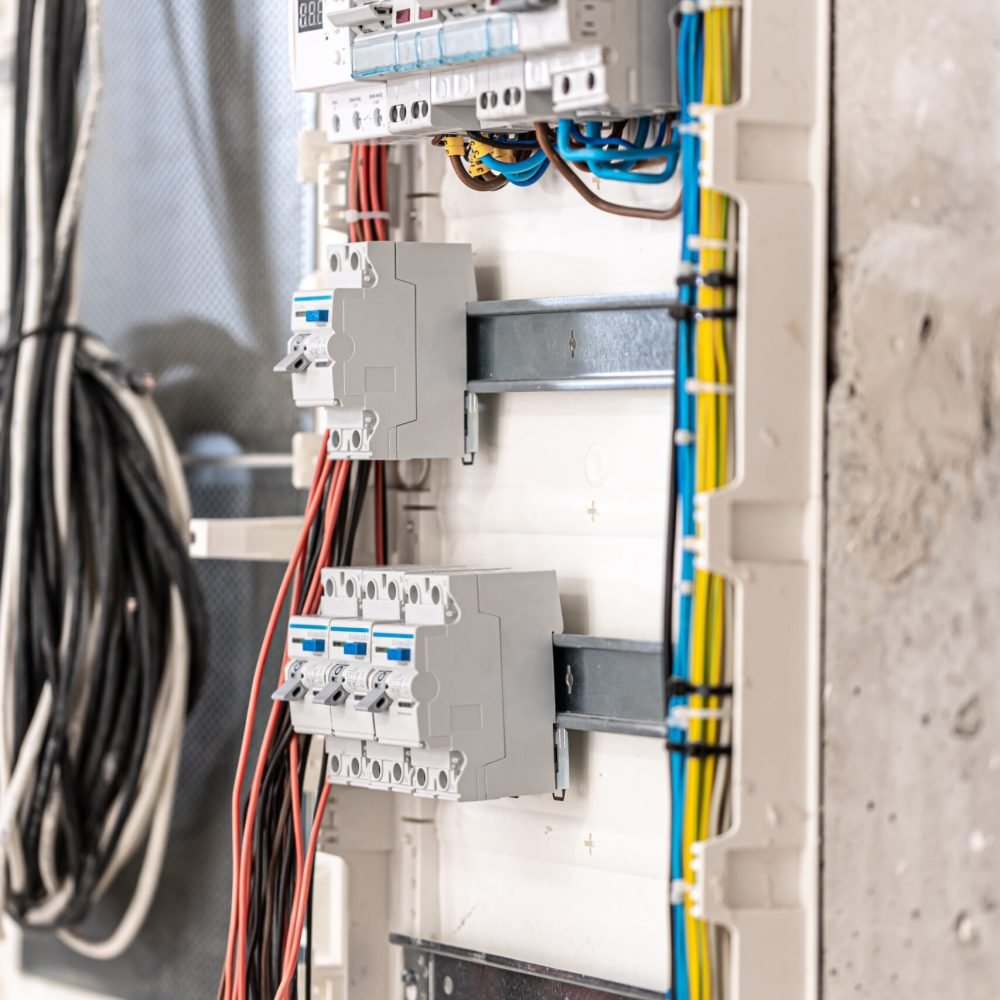 Voltage switchboard with circuit breakers, close up. Voltage switchboard with circuit breakers are in the ON and OF positions in the big electric box for electrical distribution panel and temporary electric cables are switched. Electrical background.